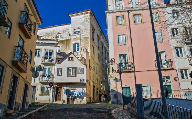 Alfama district traditional pedestrian narrow street, Lisbon Portugal